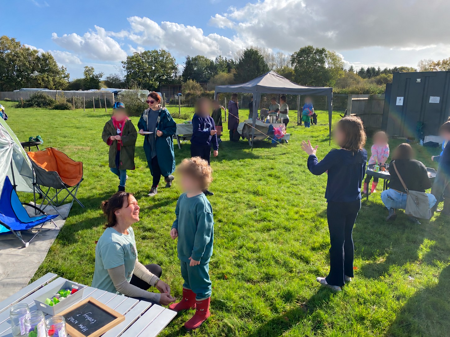 Families and children exploring activities in the main field at Flourishing’s first event